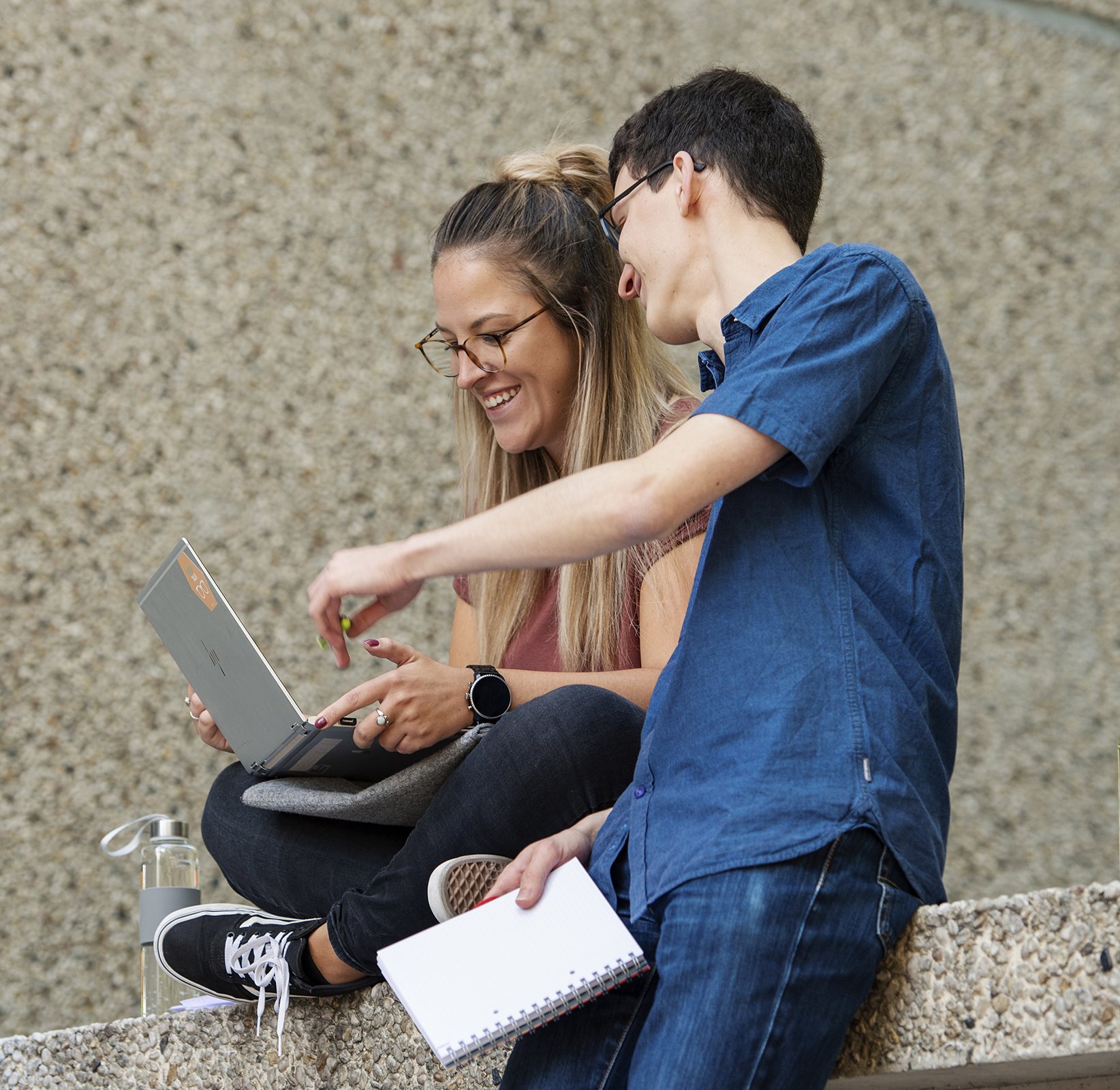 two students with laptop