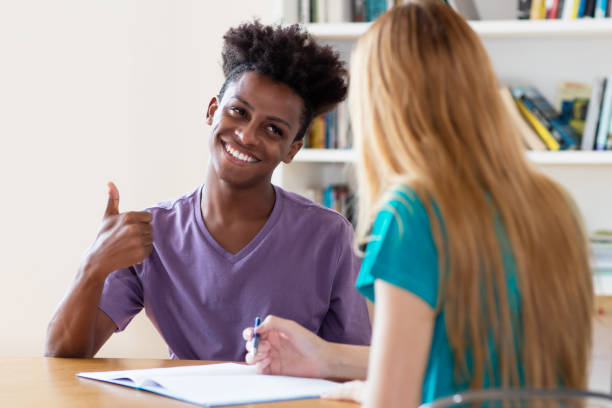 African american male student preparing for exam on private lesson at university Student bei der Beratung