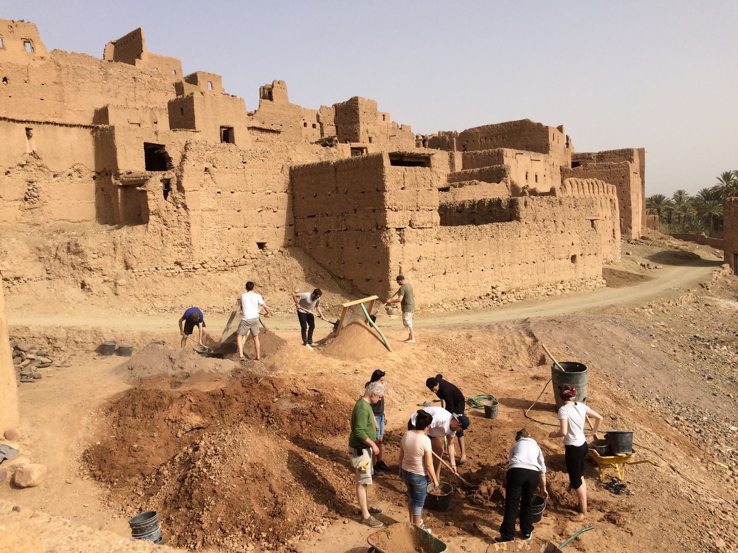 young people working on a construction site in the desert