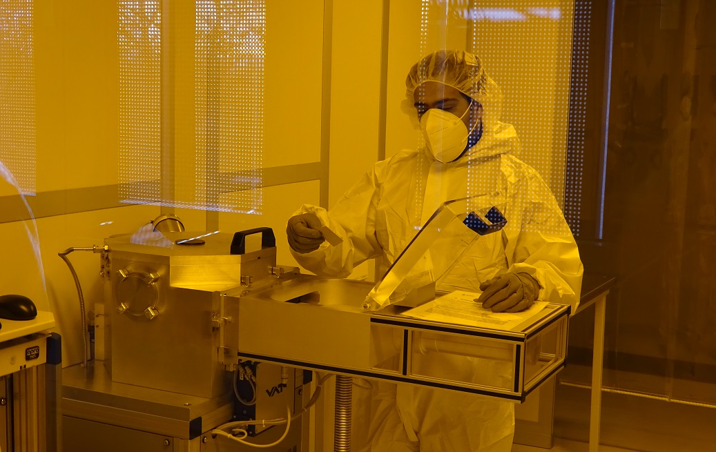 student wearing protective clothing working in the clean room