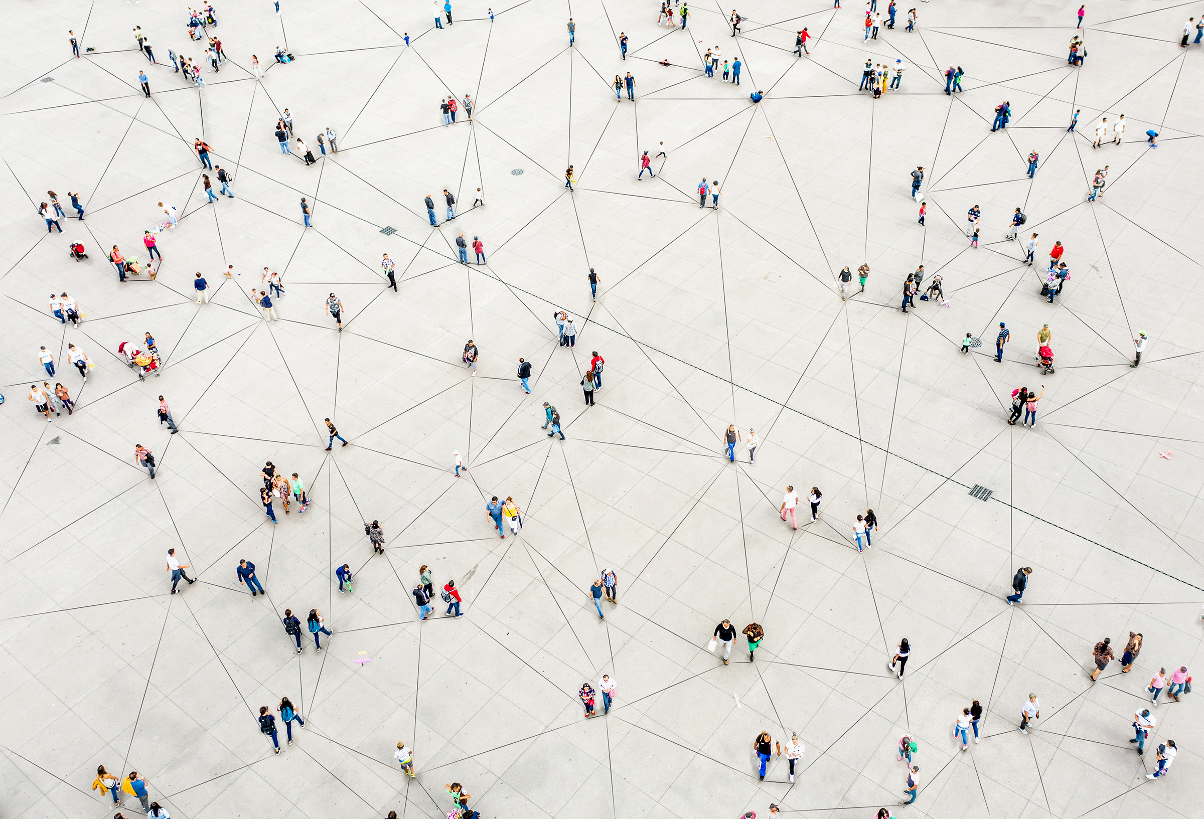 Aerial view of a network of groups of people connected by lines