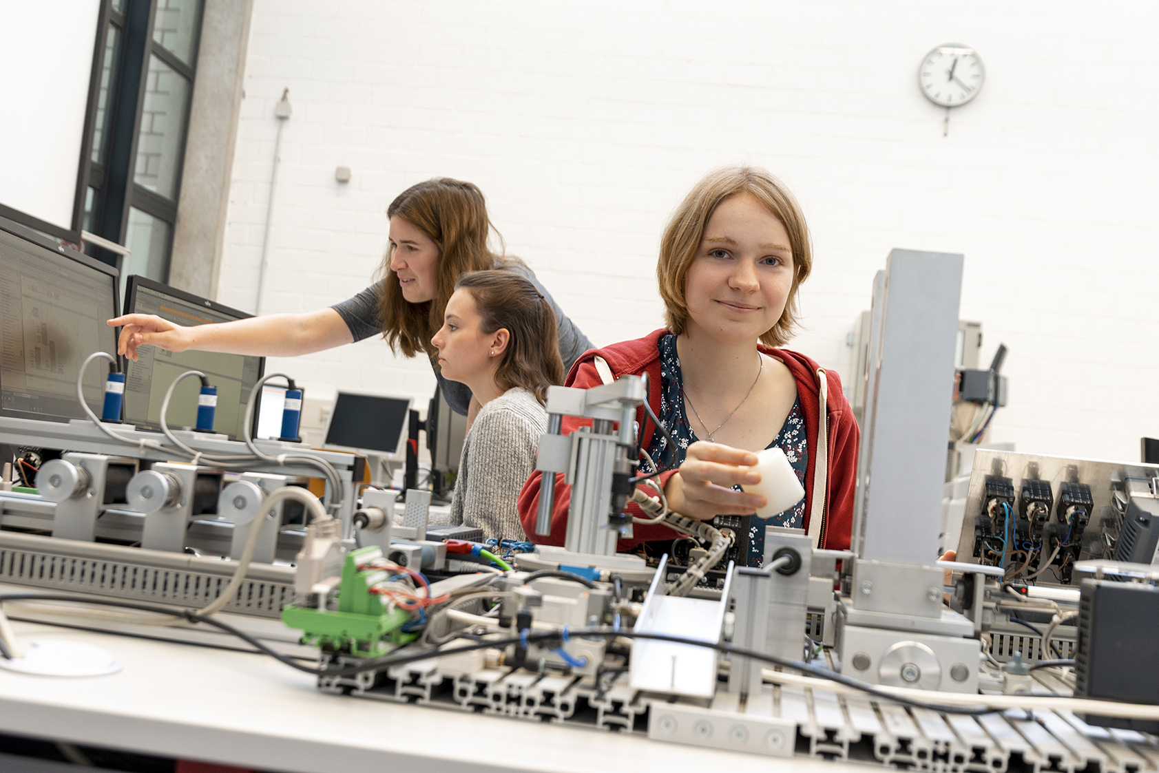 young women experimenting with machines at the lab