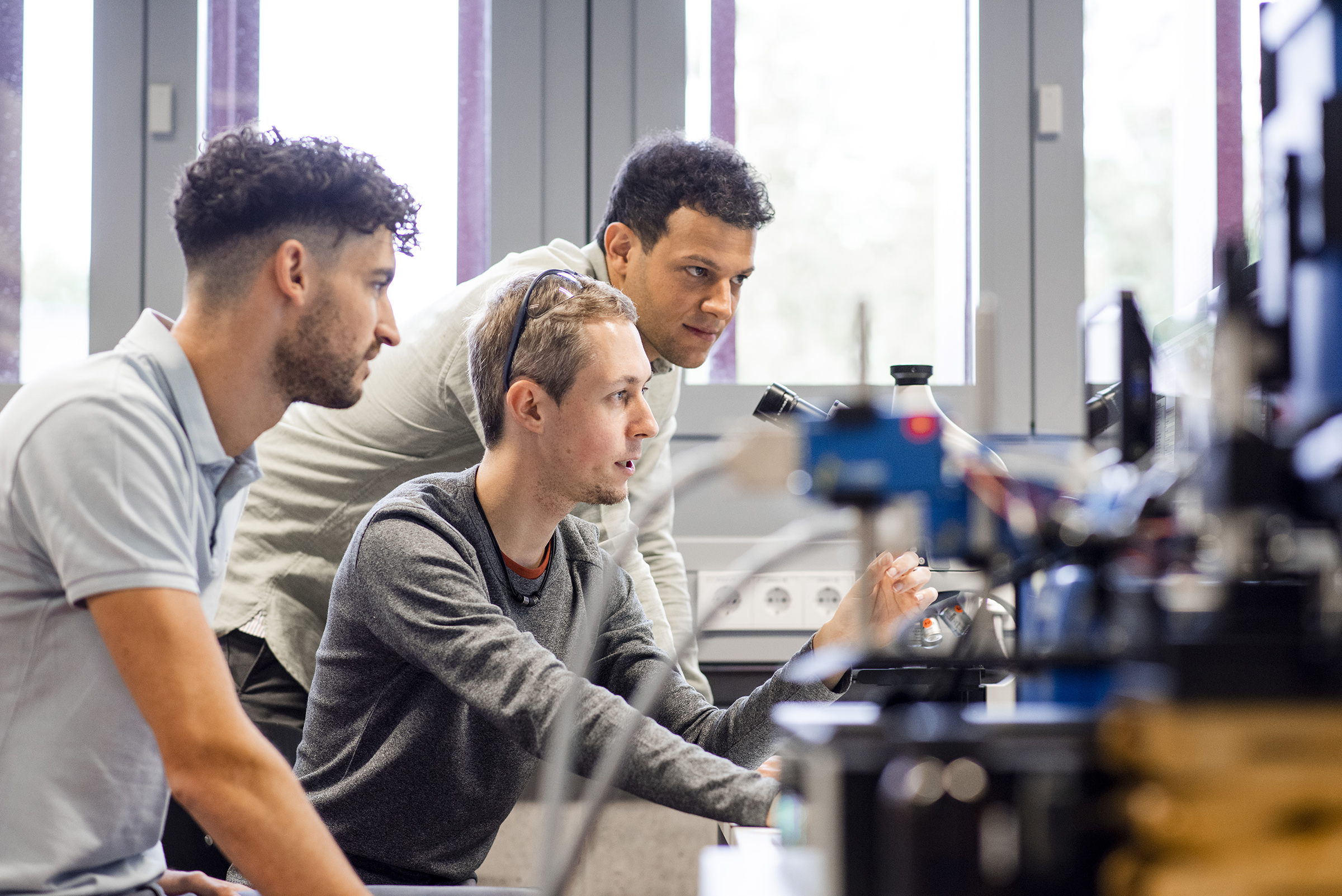 students in a lab, surrounded by equipment students in a lab, surrounded by equipment