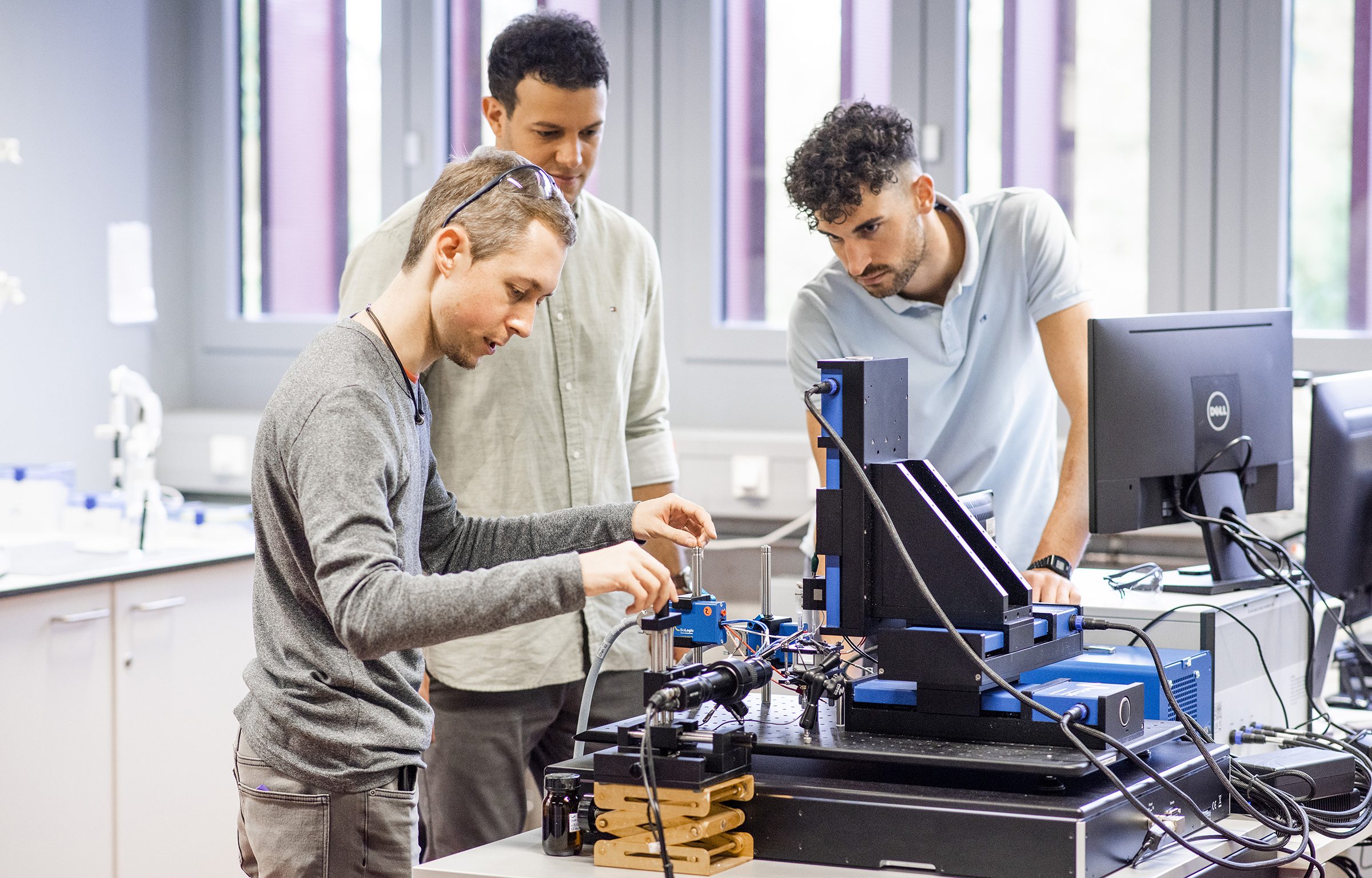 three students working on a sensor experiment at the HKA lab