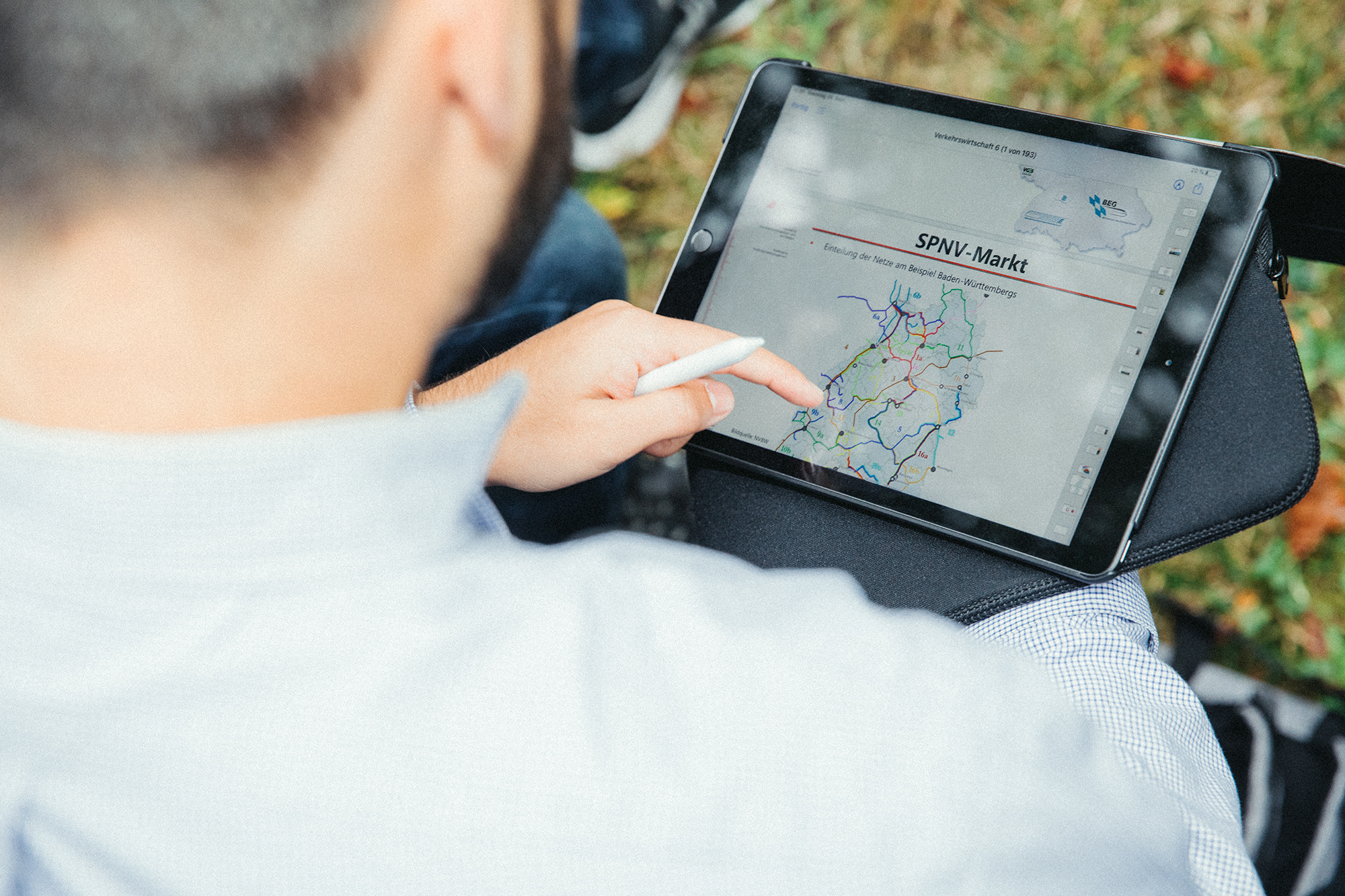 Finger tracing traffic routes on a map of Baden-Württemberg on a tablet