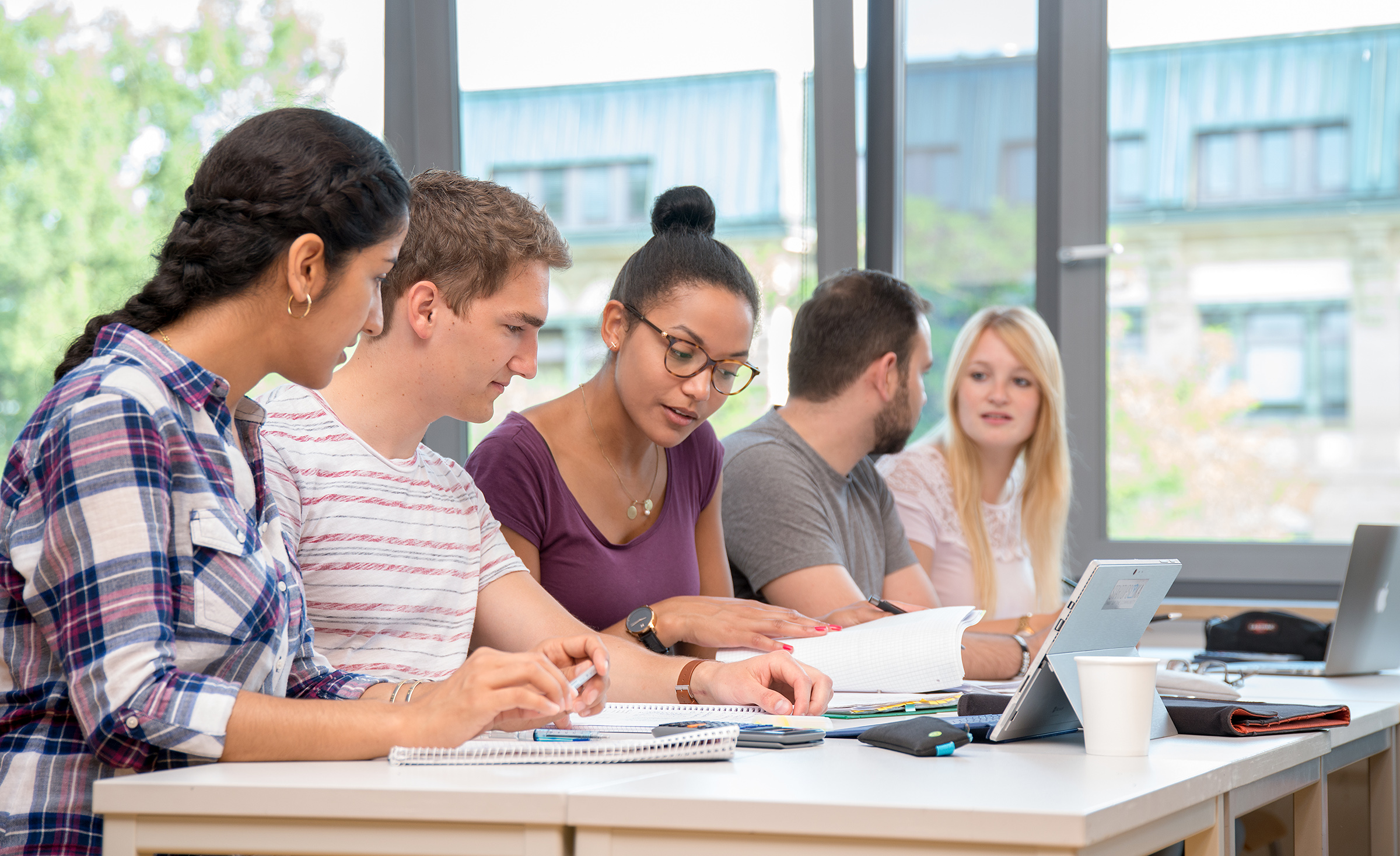 A working group of international students sitting at a table