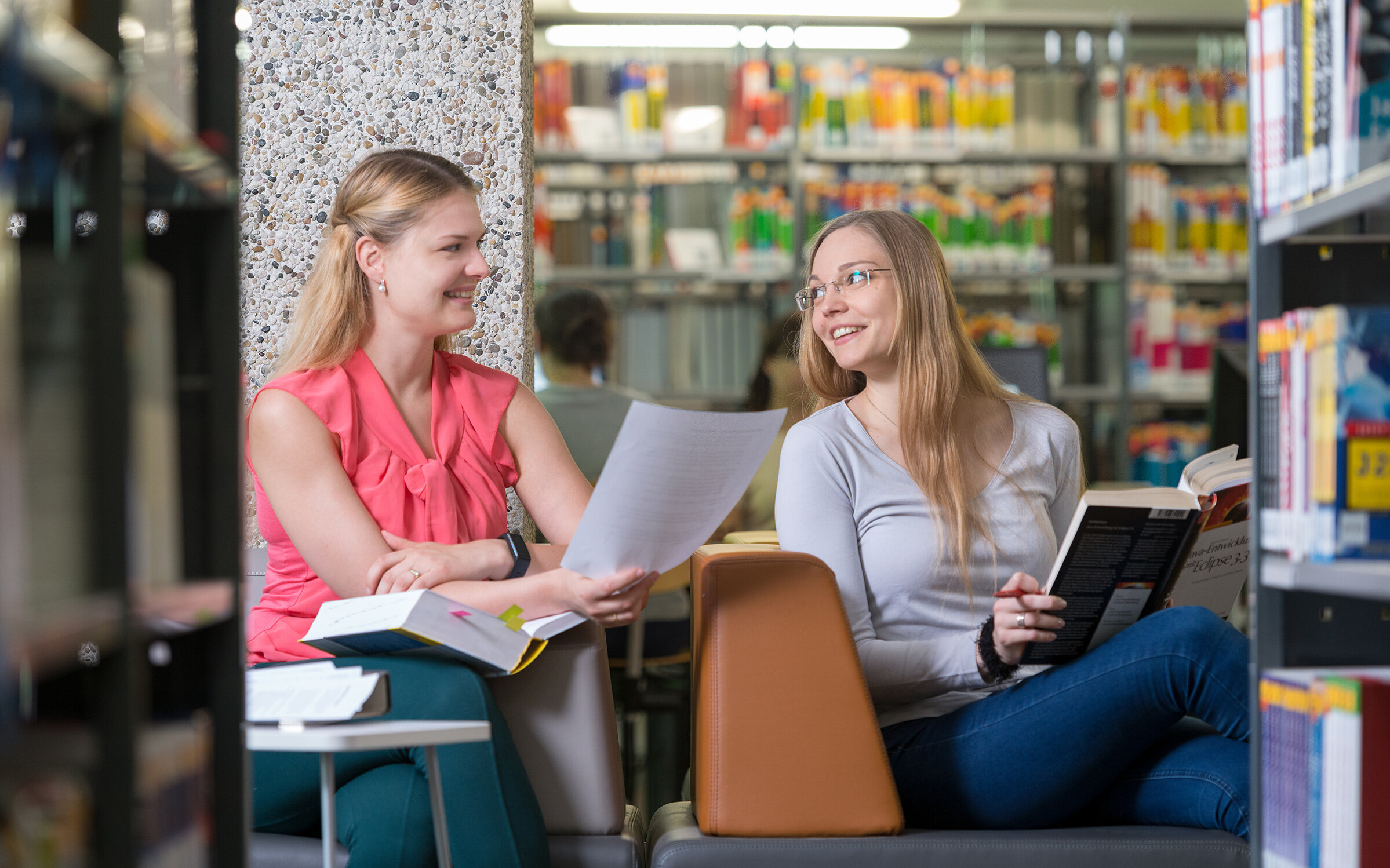 two students reading in the library