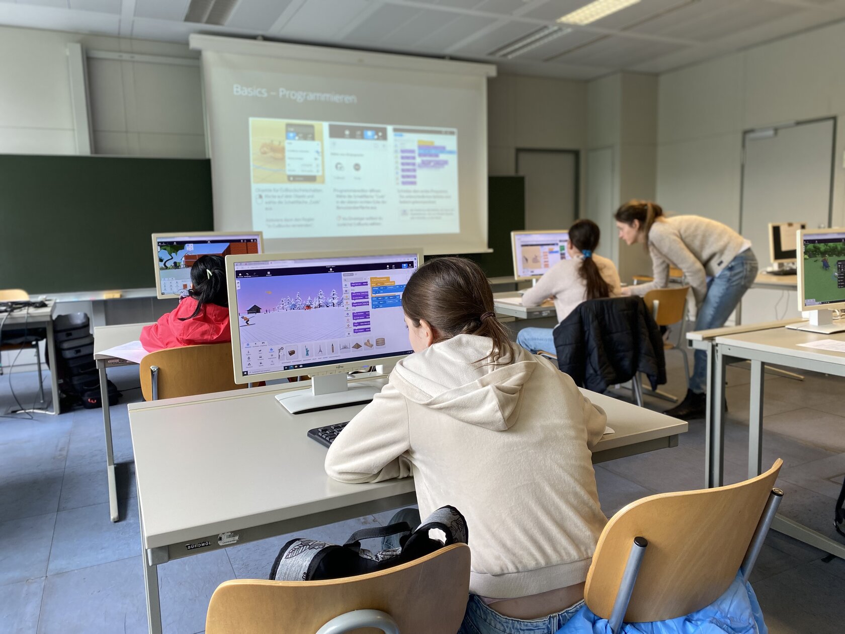 Die Teilnehmerinnen sitzen am Computer und lernen mit der App CoSpaces lernten die Teilnehmerinnen Grundlagen des Programmierens, um ihre eigenen VR-Lernwelten zu erstellen.