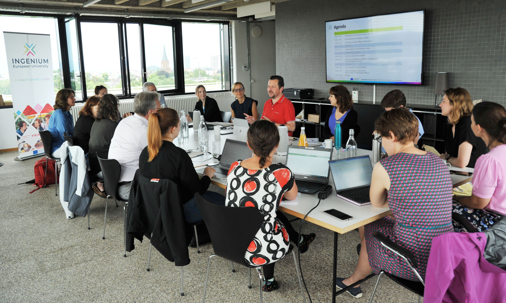 Discussion of several peopl at a conference table
