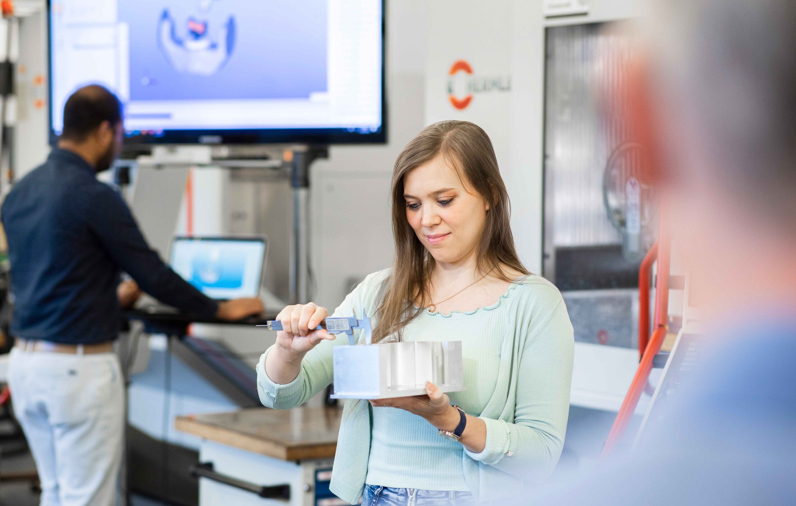 young woman measuring a workpiece young woman measuring a workpiece