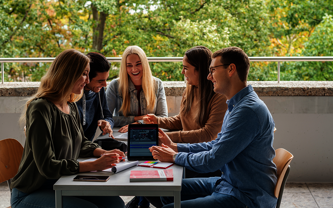 Gruppe von Studierenden am Tisch in der Interaktion