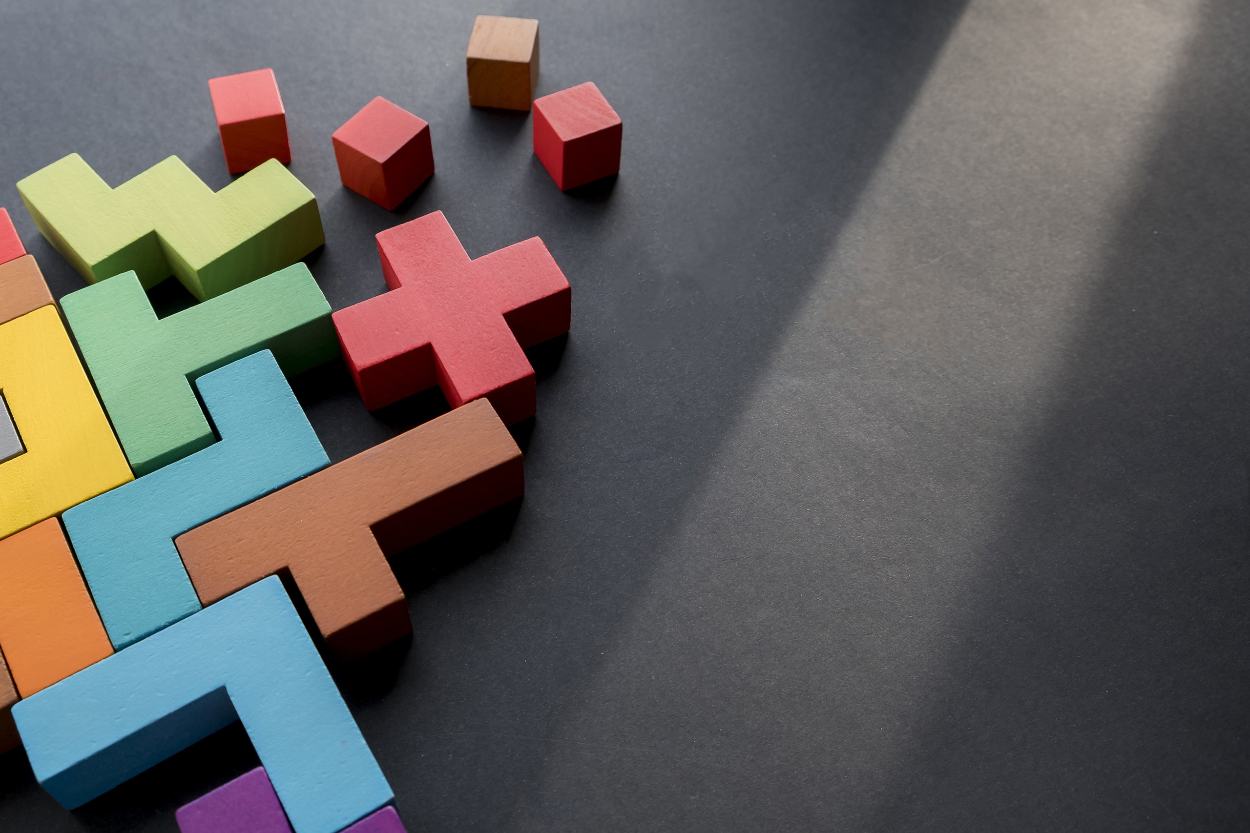 differently coloured and shaped blocks put together tetris-style