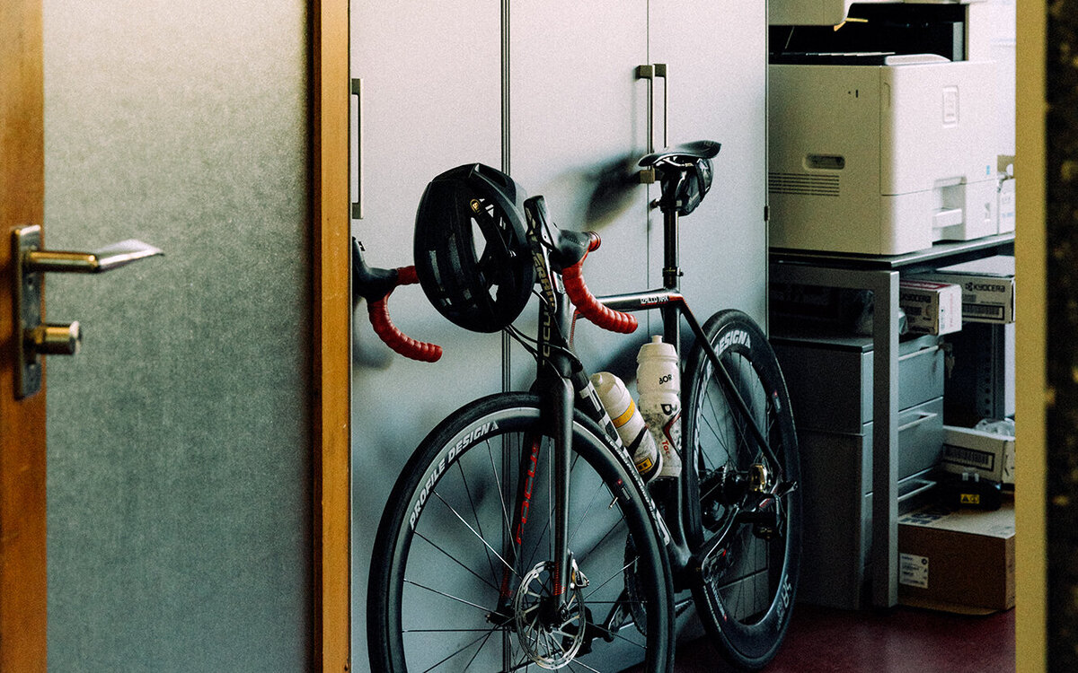 racing bike stowed against an office cabinet