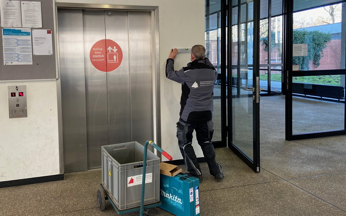 HKA employee checking the panel of an elevator