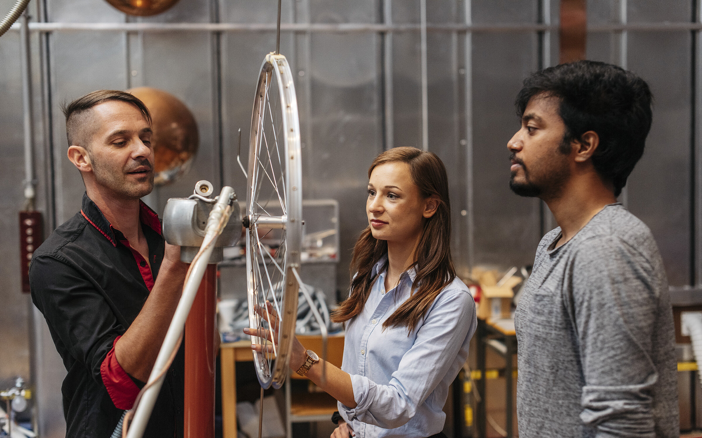 lecturer and two students preparing an experiment at the high voltage lab