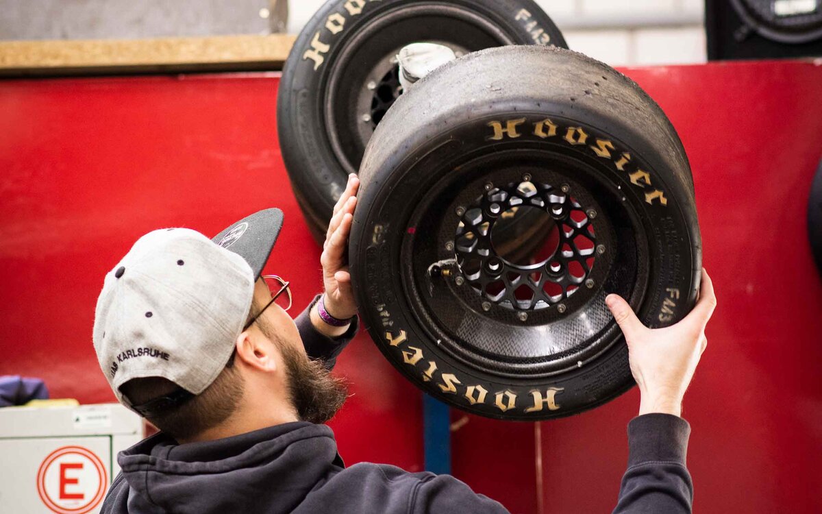 student fixing a wheel