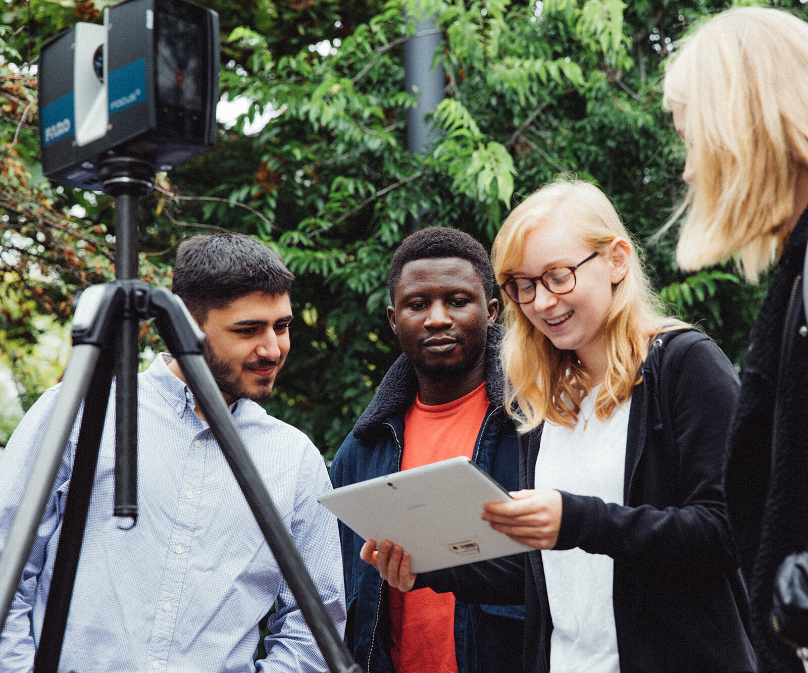 group of students around a theodolite