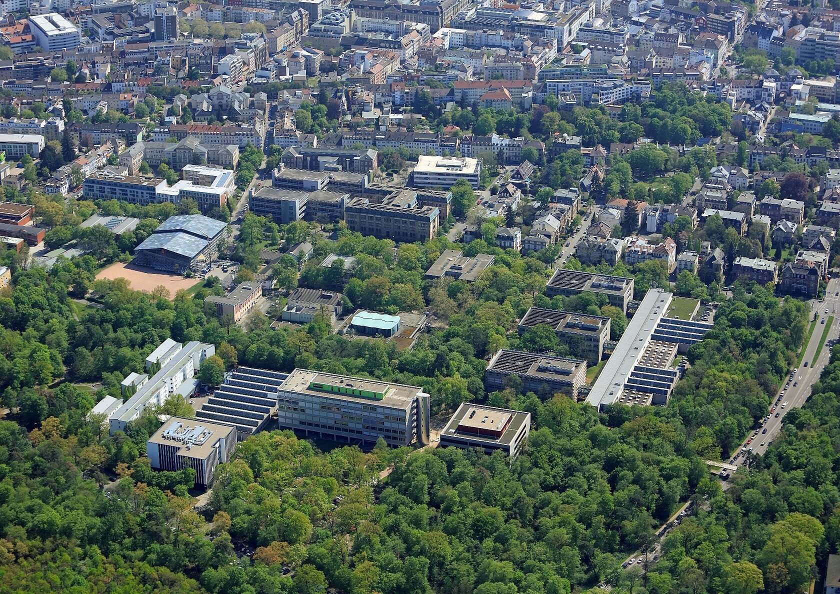 Aerial view showing the campus surrounded by trees