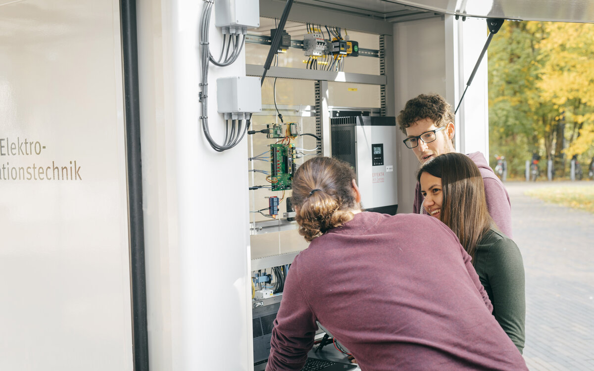 students checking the inside of the solar truck