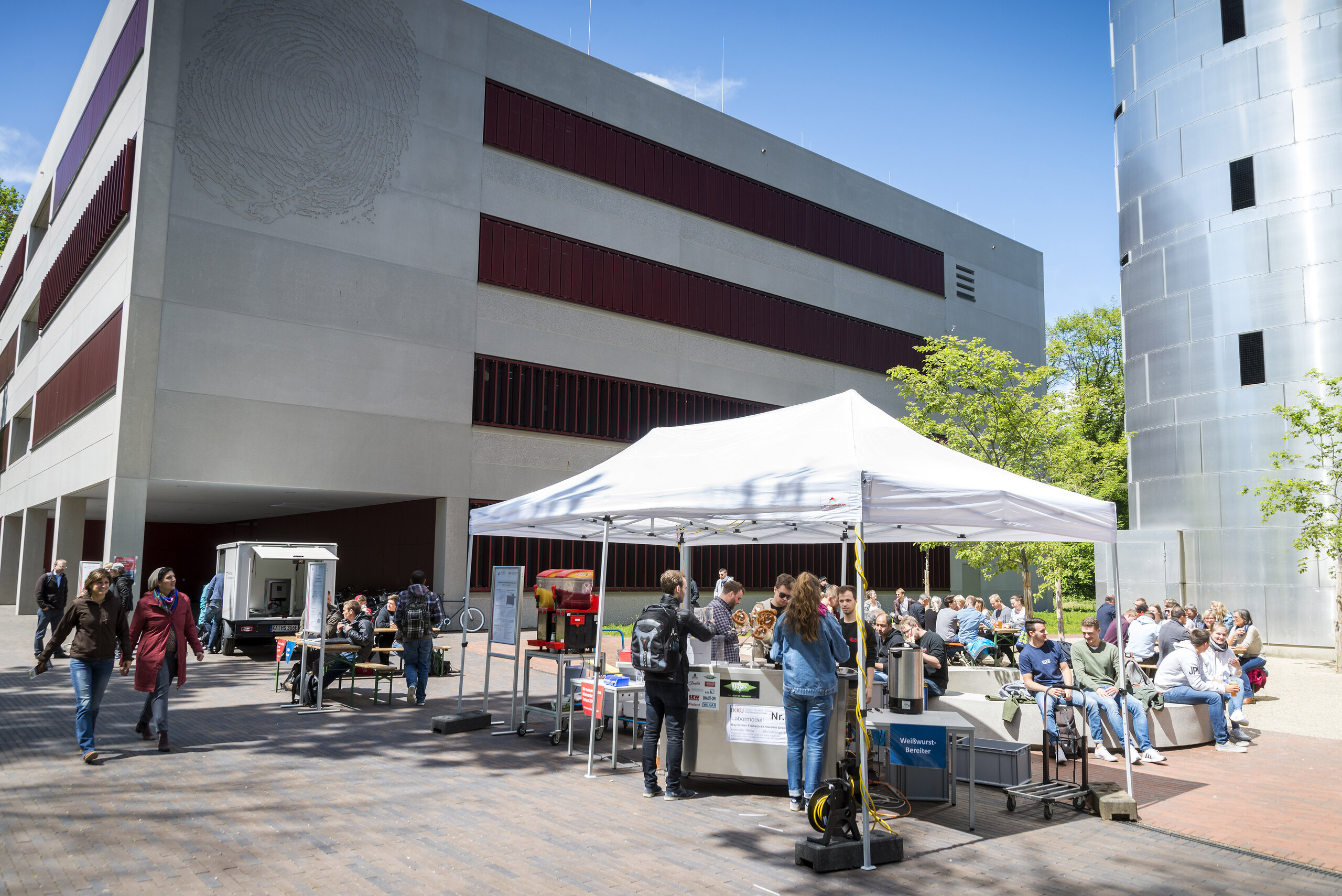 event with students, umbrellas, food stations taking place in front of the N building