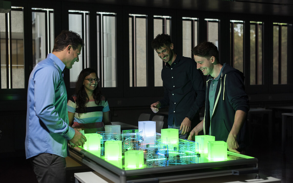 students grouped around display of an electricity grid