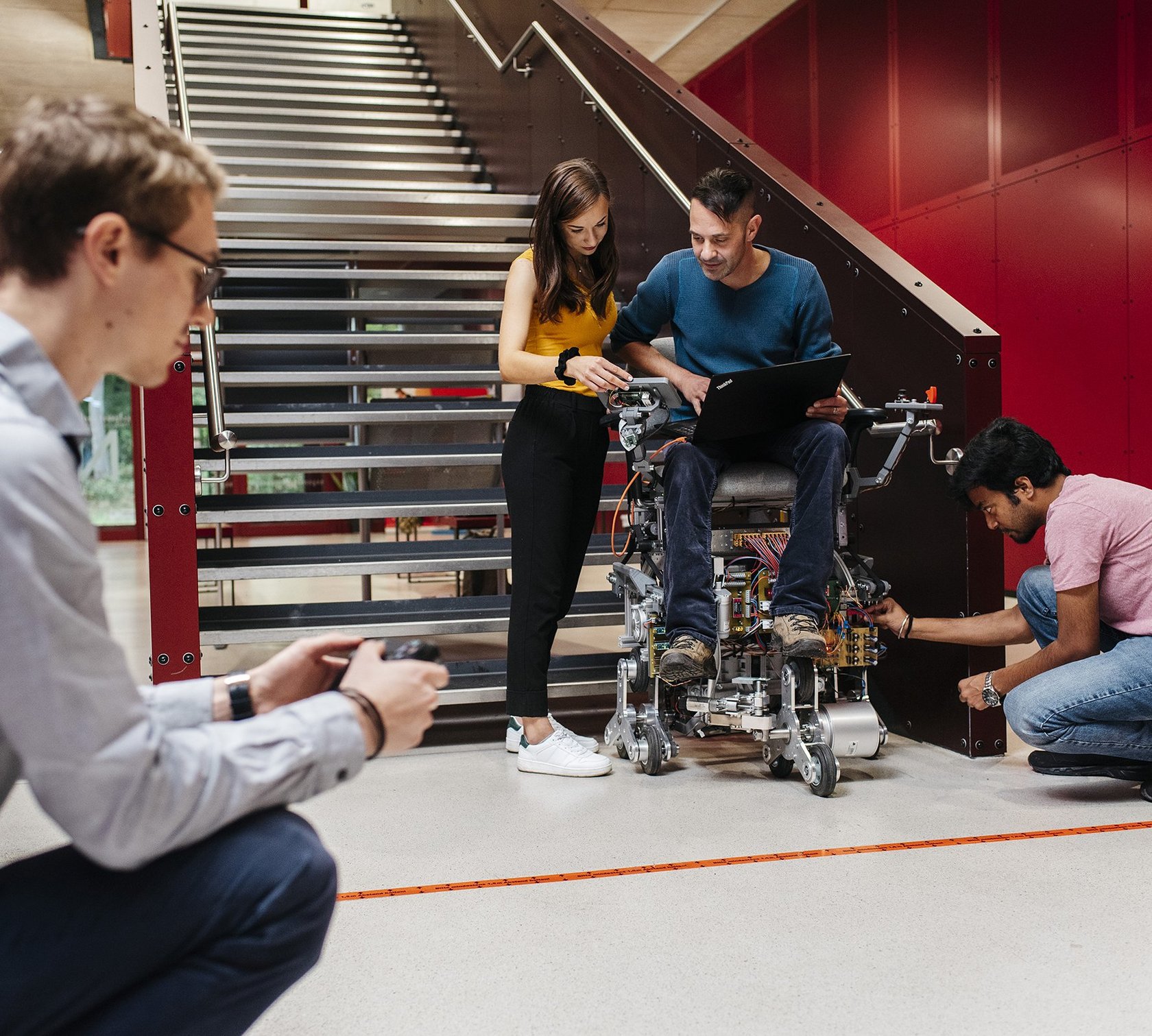 a student team uses the stairs at building N to try out a stair-climbing robot