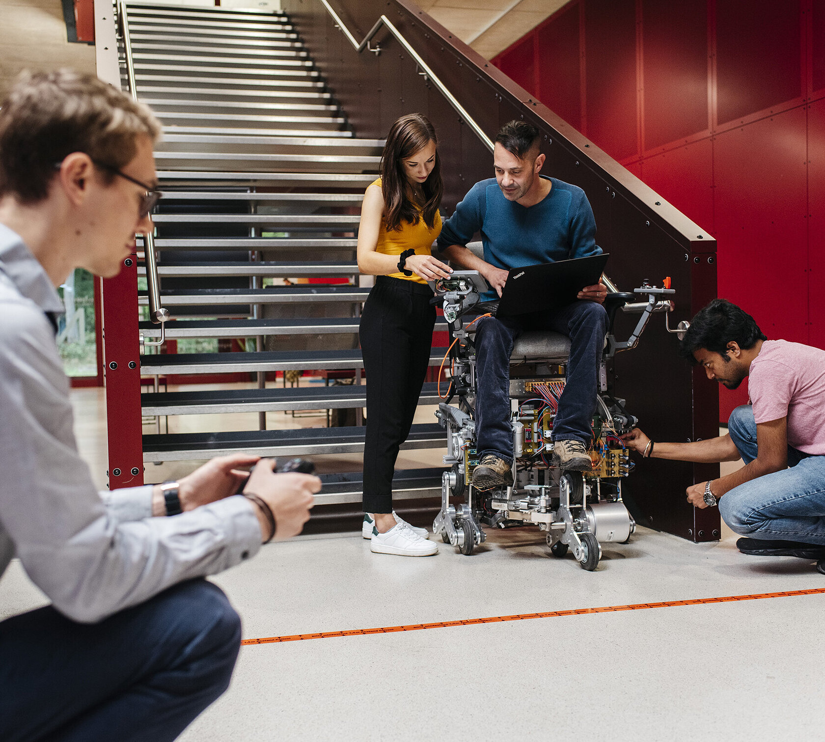 a student team uses the stairs at building N to try out a stair-climbing robot