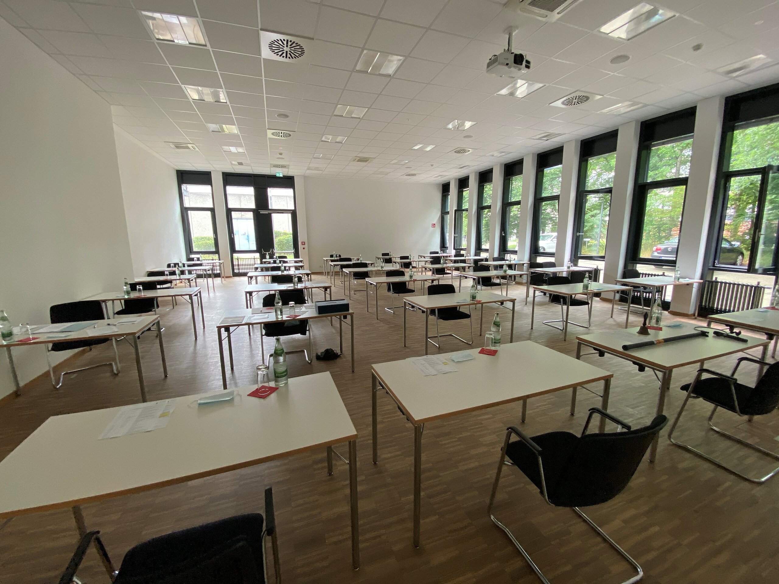 seminar room with single tables placed apart in rows ready for an exam