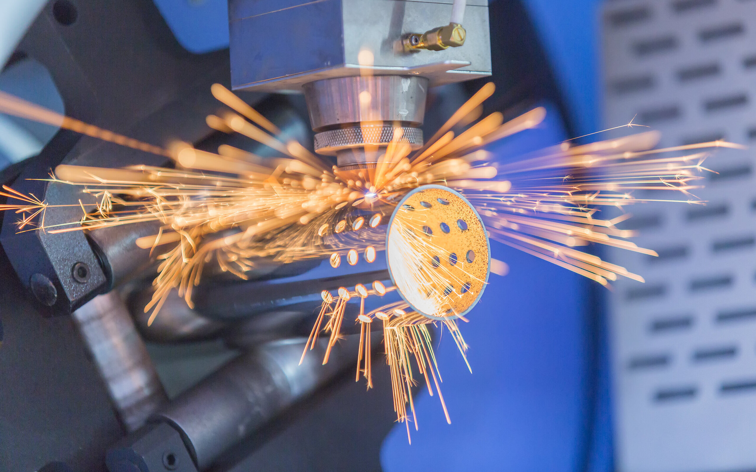 Machine boring holes in a component, sparks flying