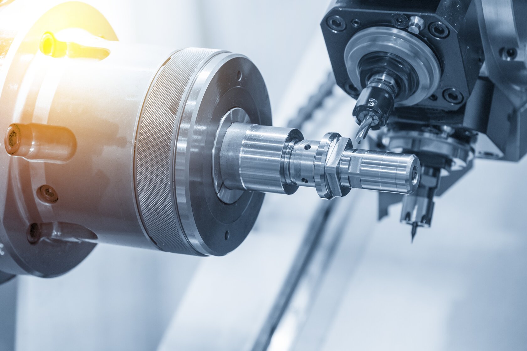The CNC lathe machine or Turning machine drilling the metal rod with the drill tool and center drill tool .The hi-technology machining concept.