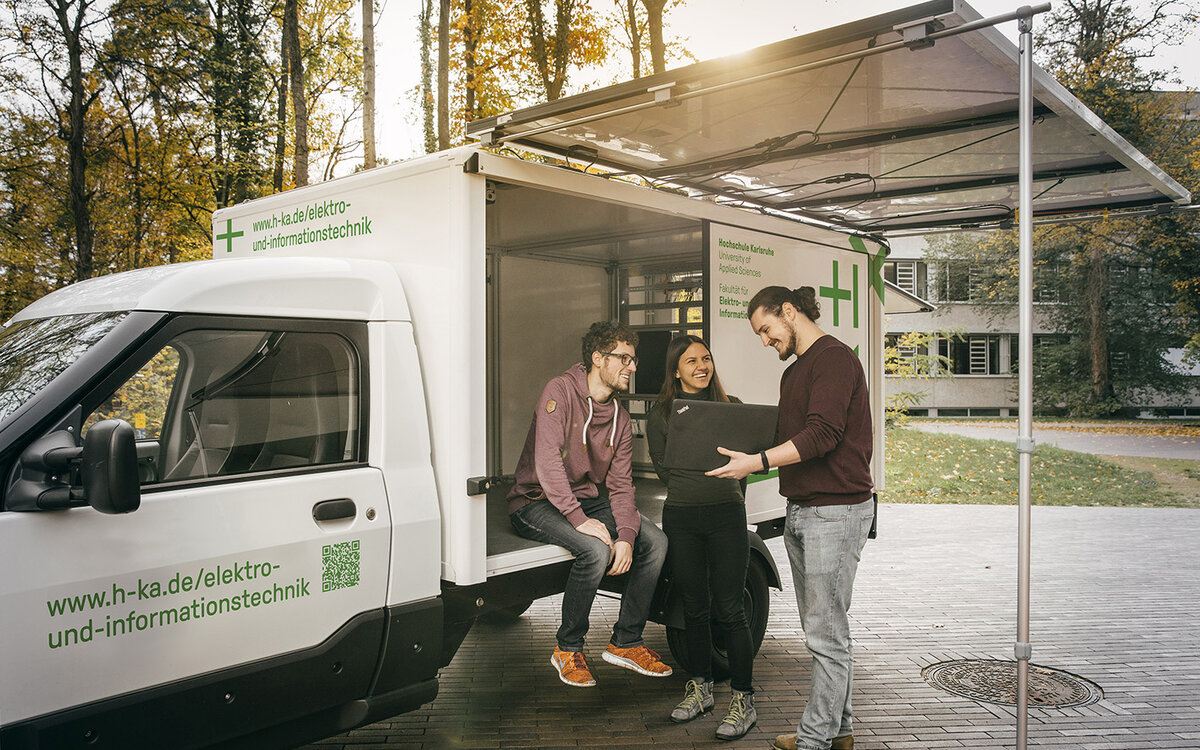 students checking the inside of the solar truck