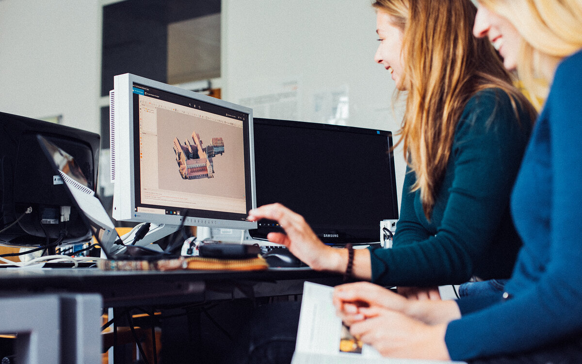 two students working at a computer station