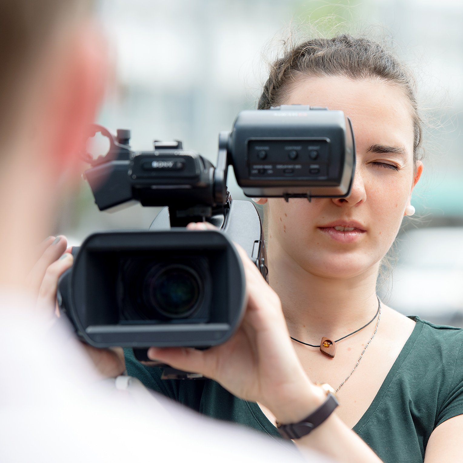 frontal view of a female student using a professional camera