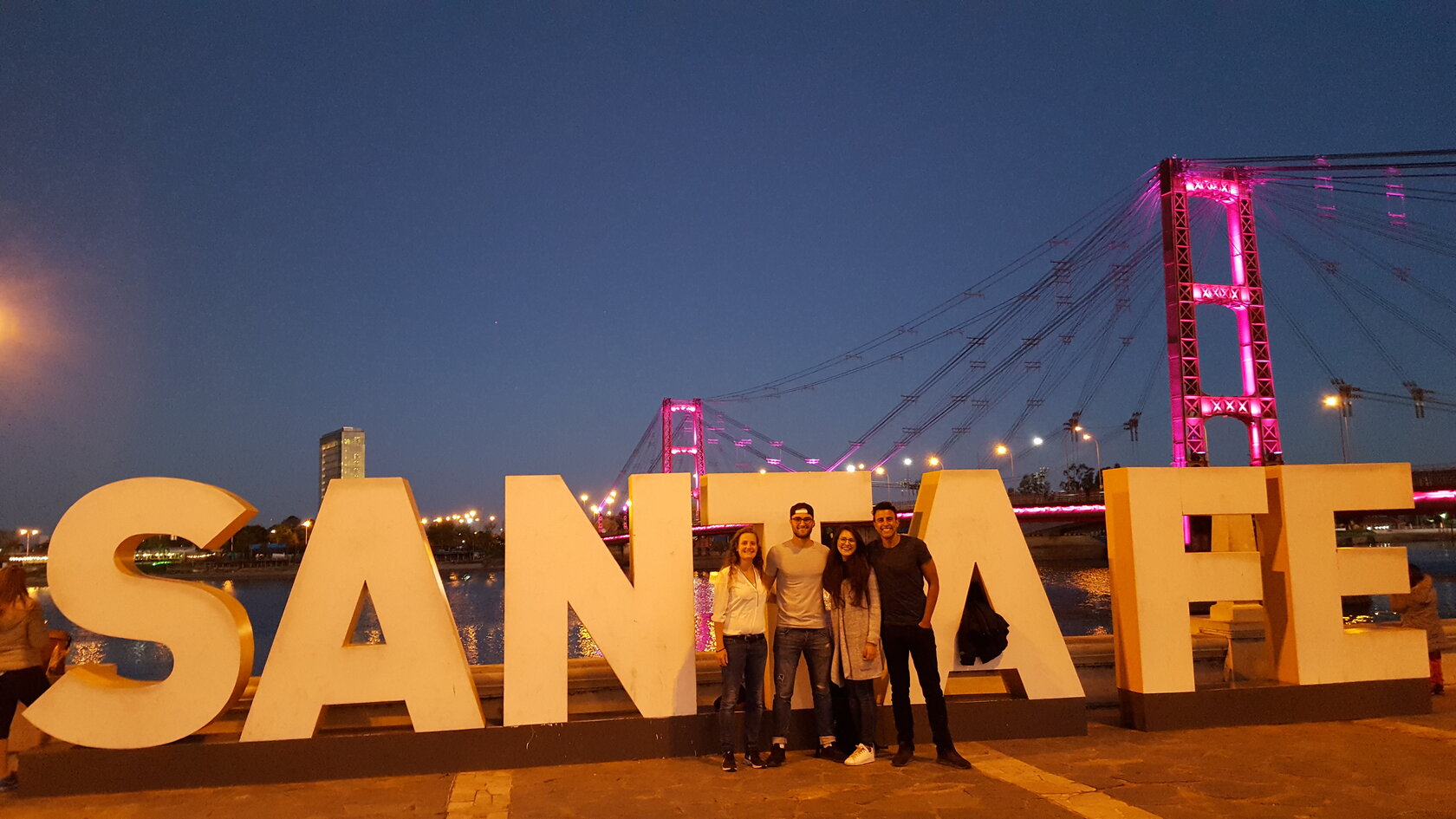 group of students standing in front of a sculpture of a big letters composing the name Santa Fe