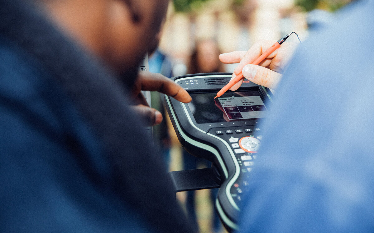 close-up of a hand writing on a control pad