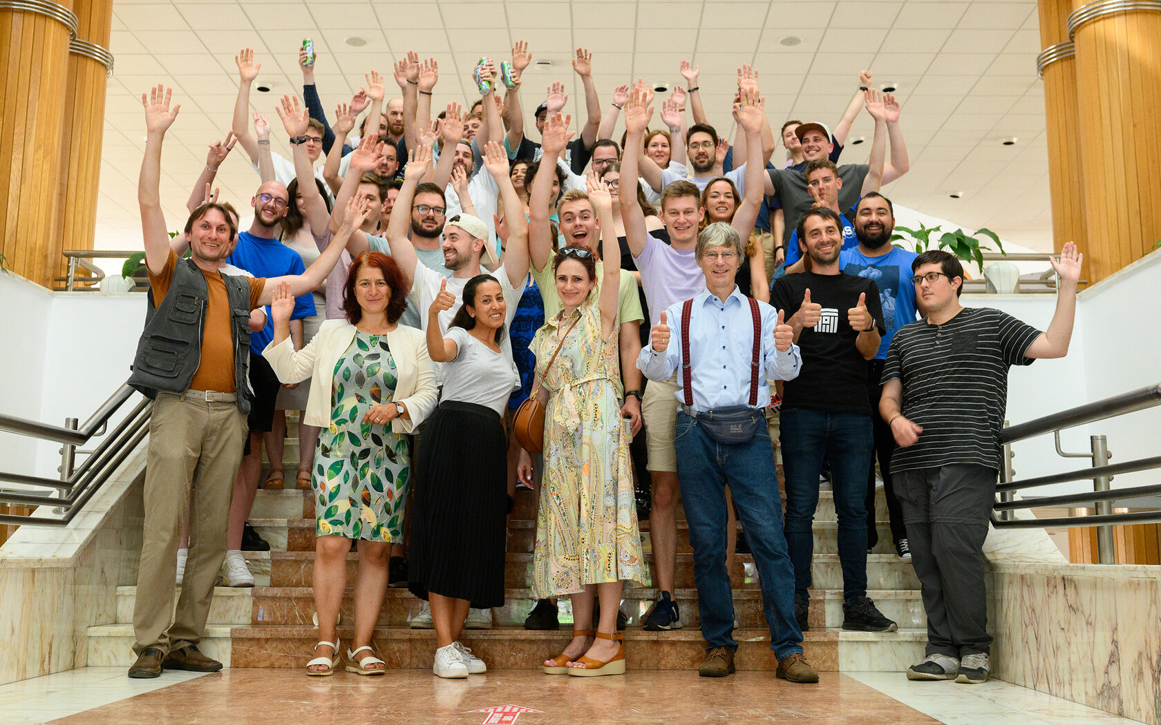 young people and lecturers waving