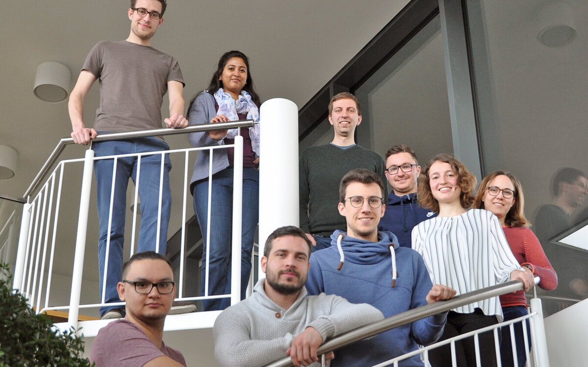 DIS employees standing on a spiral stair