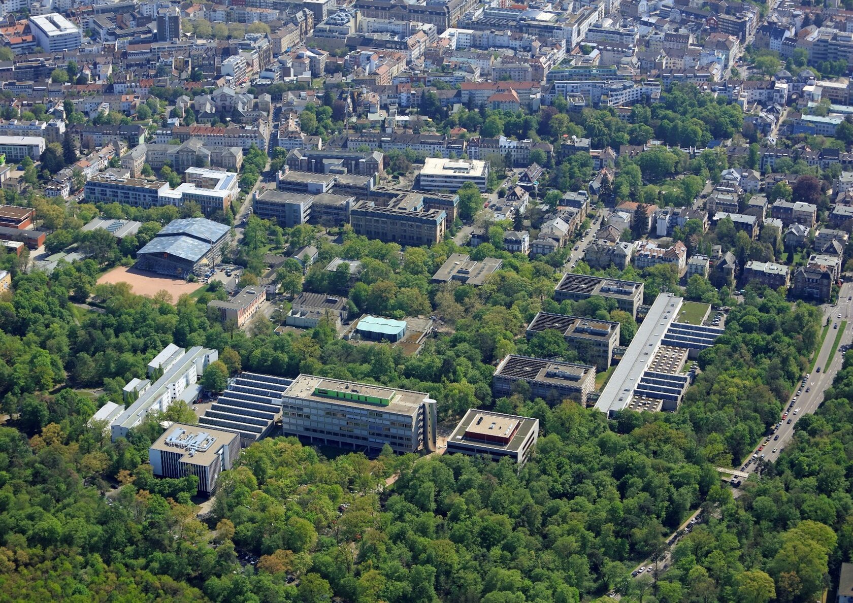 Aerial view showing the campus surrounded by trees Aerial view showing the campus surrounded by trees