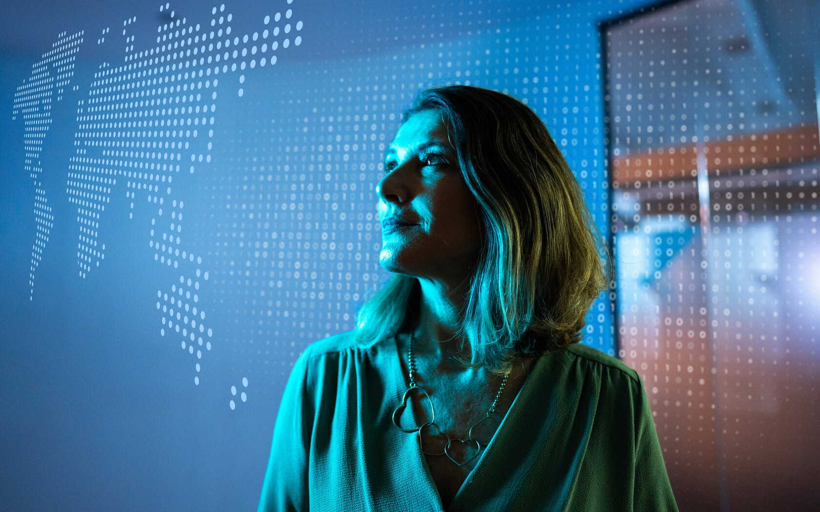 Mature businesswoman looking to a hologram at office