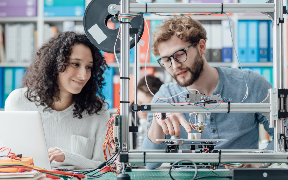 young man and woman carrying out an experiment in the lab