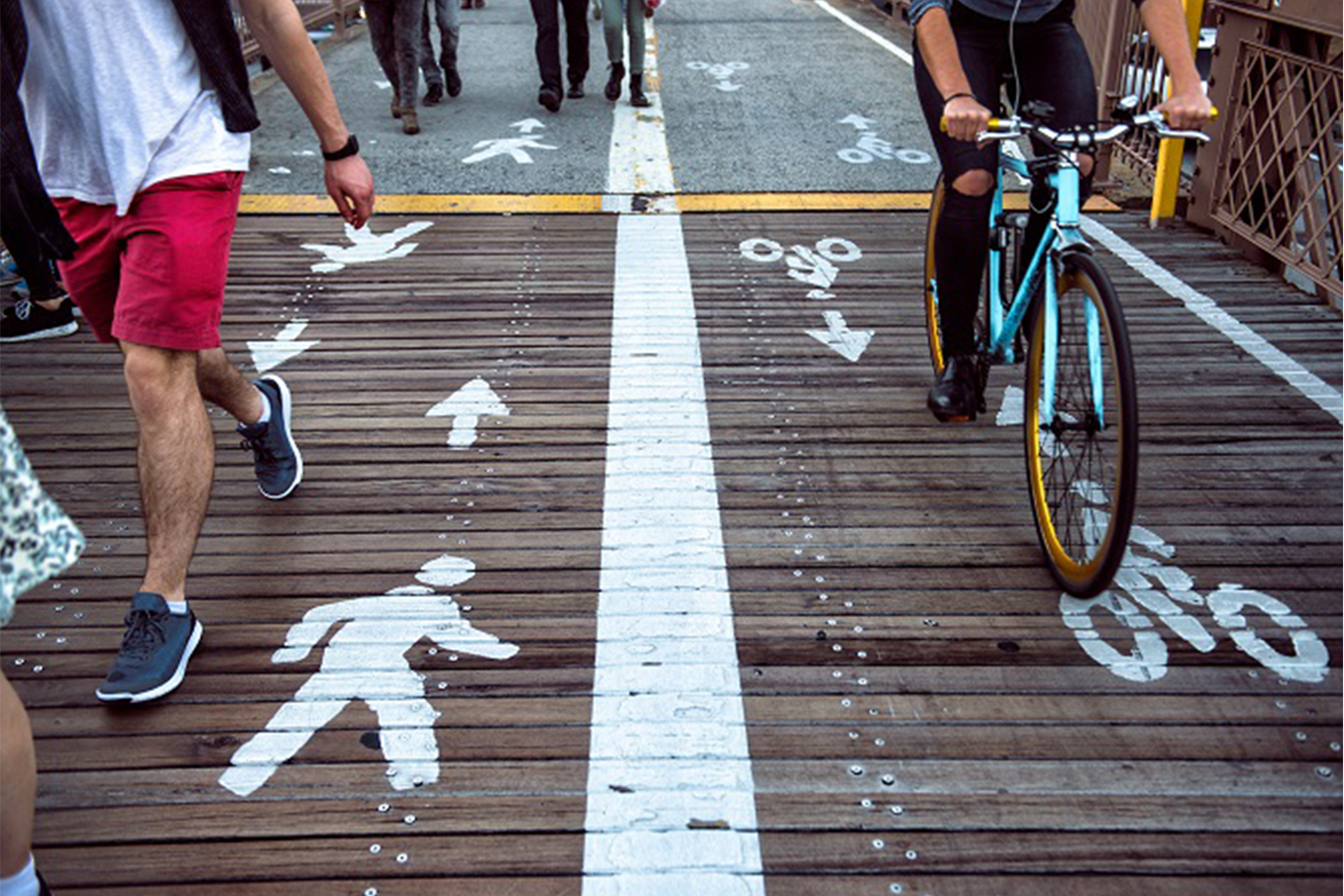 close-up of wooden-plank way with lanes for pedestrians and bikes marked close-up of wooden-plank way with lanes for pedestrians and bikes marked